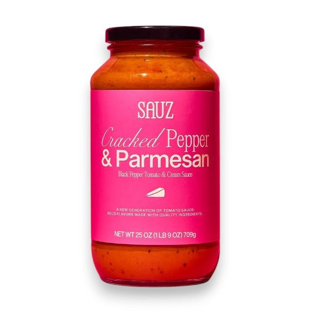 A jar of SAUZ - CRACKED PEPPER &amp; PARMESAN sauce from SAUZ, made with California grown tomatoes and displayed in a jar featuring a bright pink label on a white background.