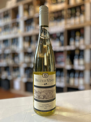 A clear bottle of BELTED VINES ALBARINO 2023 from WINE: 3 KEYS, a crisp California white wine, with a cream label depicting a vineyard and a cream screw cap.