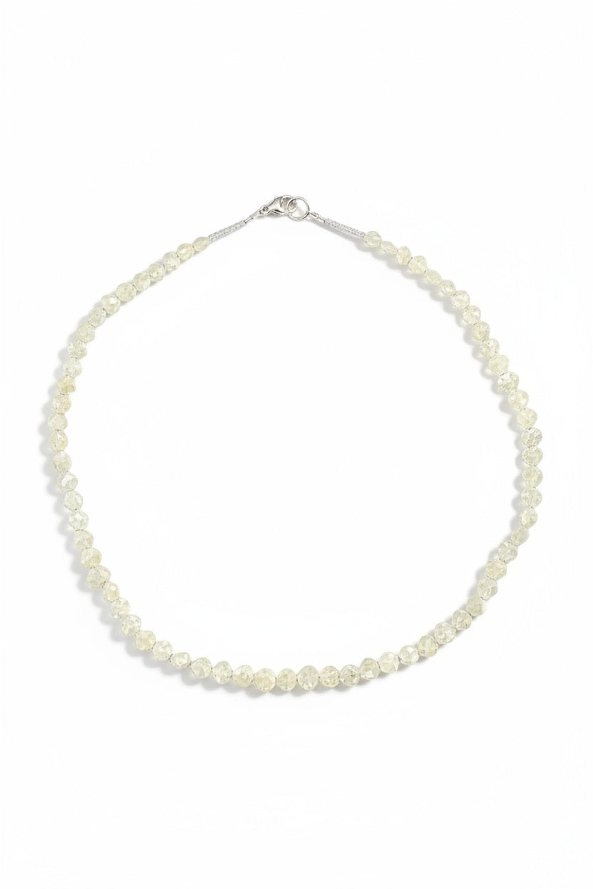 The ANN LIGHTFOOT Faceted Sillimanite and Quartz Ras du Cou Necklace features small, translucent pale yellow gemstones in an irregular single strand with a sterling silver clasp.