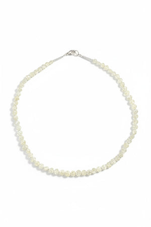 The ANN LIGHTFOOT Faceted Sillimanite and Quartz Ras du Cou Necklace features small, translucent pale yellow gemstones in an irregular single strand with a sterling silver clasp.