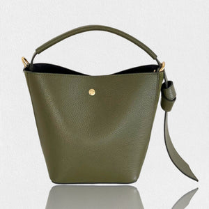 Introducing the SMALL LEATHER BUCKET HANDBAG by LE BORSETTE: This sleek white handbag boasts a structured design with a single top handle and detachable crossbody straps. With its minimalistic style and tiny gold accent on the front, its clean lines and smooth texture provide a modern, sophisticated look.