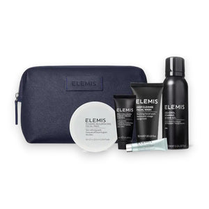 The ELEMIS - MEN'S 1ST CLASS GROOMING KIT by ELEMIS - STEINER features a dark blue travel bag behind five men's skincare products, including facial wash, Pro-Collagen Marine Cream for Men, two tubes, a small bottle, and shaving gel.