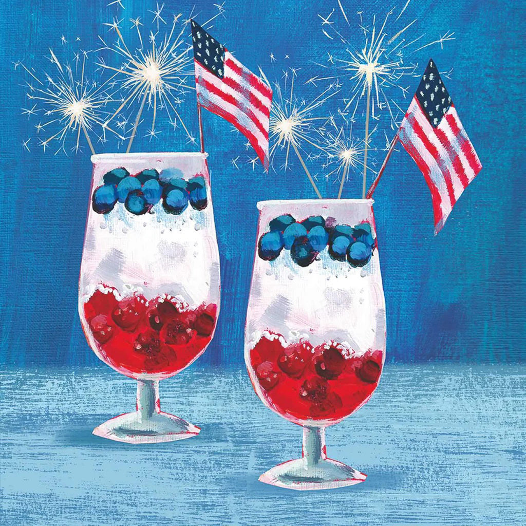 An illustration showcasing two glasses filled with red, white, and blue layered ingredients to evoke a patriotic vibe. Each glass is topped with blueberries, sparklers, and small American flags. The beverages are placed on PAPER PRODUCTS DESIGN's PATRIOTIC PARFAIT BEVERAGE NAPKINS on a textured blue surface.