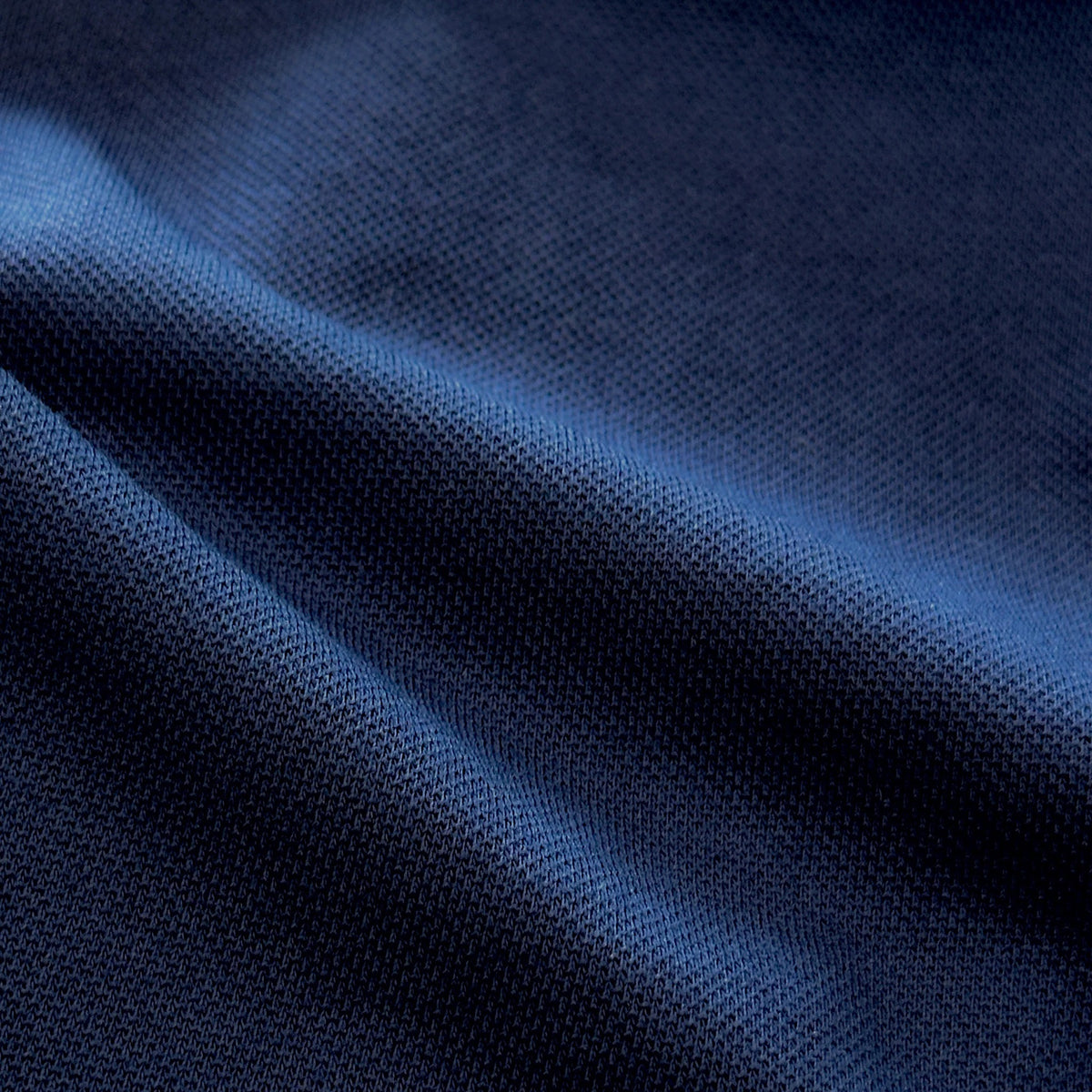 Close-up of COLLARS AND CO's PALM PIMA BLEND QUARTER ZIP IN NAVY, featuring dark blue fabric with a soft, textured surface and subtle sheen—perfect for lightweight layering and modern comfort.