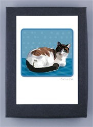 The PAPER RUSSELS - CALICO CAT NOTE CARDS by PAPER RUSSELLS feature an illustration of a cat lounging comfortably. This adorable feline has a white body with brown and black patches and is depicted against a blue background with dots. In the lower right corner, you can find the text &quot;Calico Cat.&quot; The artwork is printed on FSC certified recycled paper, ensuring it is both charming and environmentally friendly.