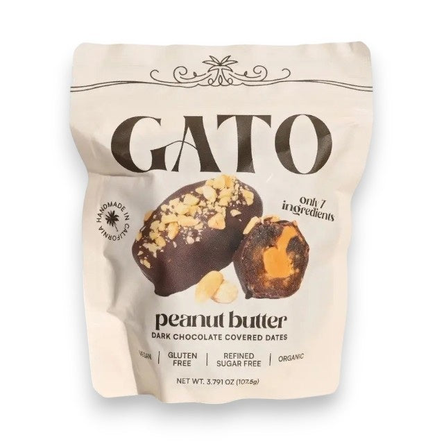 A pouch of GATO DATES - CHOCOLATE COVERED PEANUT BUTTER DATES from GATO DATES, featuring an image of the snack topped with nuts. The packaging highlights that it is plant-based, vegan, gluten free, refined sugar free, and organic.