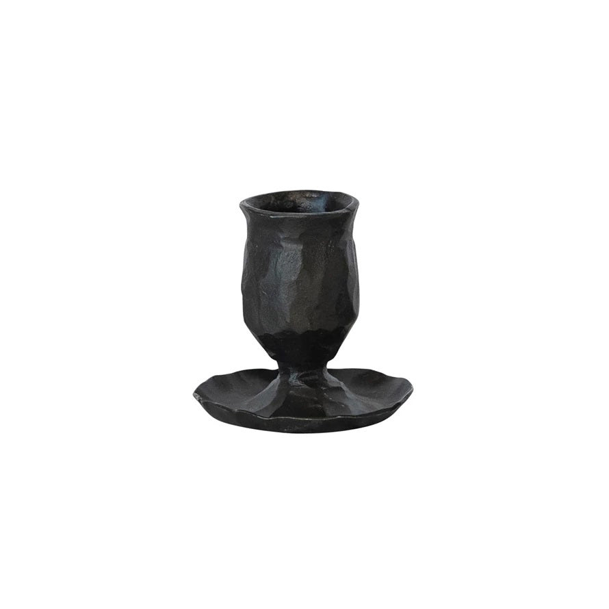 Black, hand-forged CREATIVE COOP HAND FORGED CAST IRON TAPER HOLDER with a hammered finish and a wide, irregular base.
