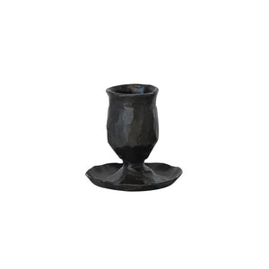 Black, hand-forged CREATIVE COOP HAND FORGED CAST IRON TAPER HOLDER with a hammered finish and a wide, irregular base.
