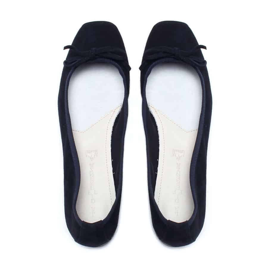 The MICHELE LOPRIORE - PALOMA ballet flat with a square toe, crafted from genuine silver leather, features a delicate bow on the front and a low-profile brown sole. Made in Italy, this elegant shoe is set against a plain white textured background.