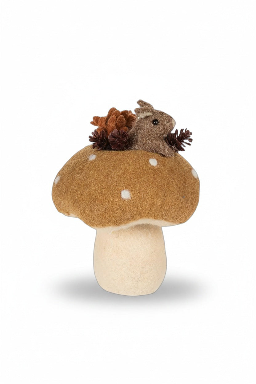 An ABBOTT MOUSE IN MUSHROOM sits atop a decorative mushroom alongside a glass squirrel candle holder, two small ceramic figures with an acorn and a pumpkin, all displayed on a stack of books for an autumn spirit.