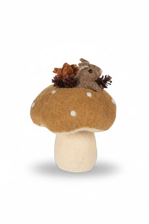 An ABBOTT MOUSE IN MUSHROOM sits atop a decorative mushroom alongside a glass squirrel candle holder, two small ceramic figures with an acorn and a pumpkin, all displayed on a stack of books for an autumn spirit.