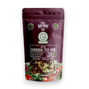 A purple bag of TO MARKET - IT’S GREEK TO ME DIP MIX by TO MARKET- DIPS & SPREADS sits beside a bowl of white dip served with crackers. The packaging highlights a 6-cup yield and features key ingredients like onion, parsley, and oregano, making it an ideal foundation for a Mediterranean spread—just add feta cheese and kalamata olives for an authentic flair.