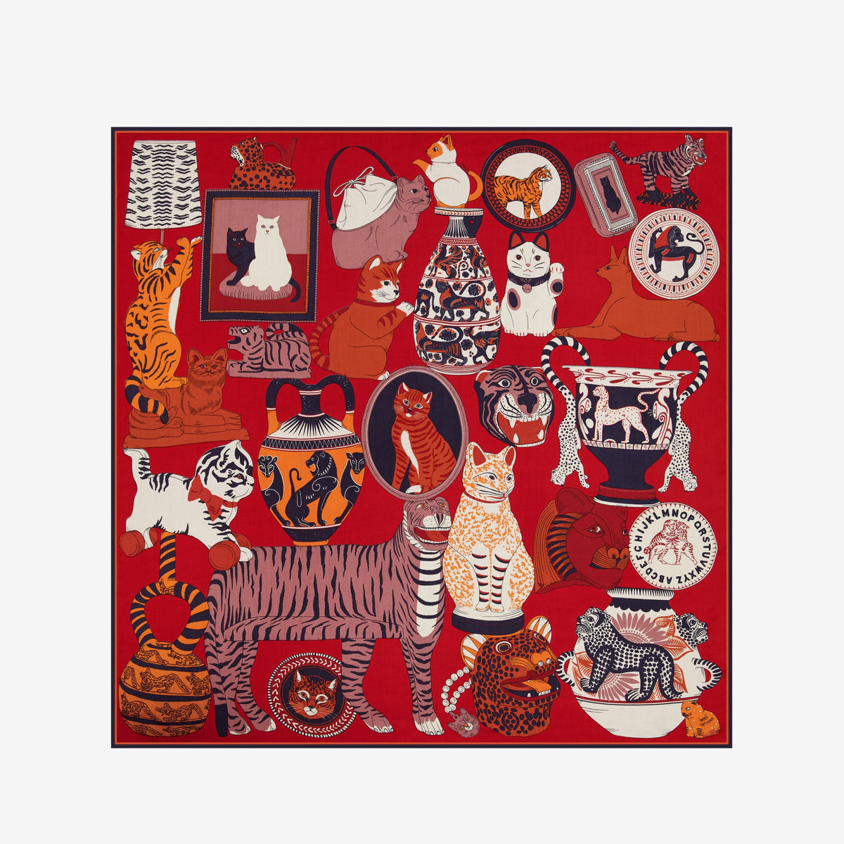 A woman with straight dark hair, dressed in a dark blazer, wears the luxurious INOUI EDITIONS - COLLECTIONNEUR SCARF WITH CATS IN MODAL SILK RED by INOUI. The red scarf—adorned with animal and wave designs and crafted from silk modal— is styled in a triangle around her neck as she stands against a plain white background.
