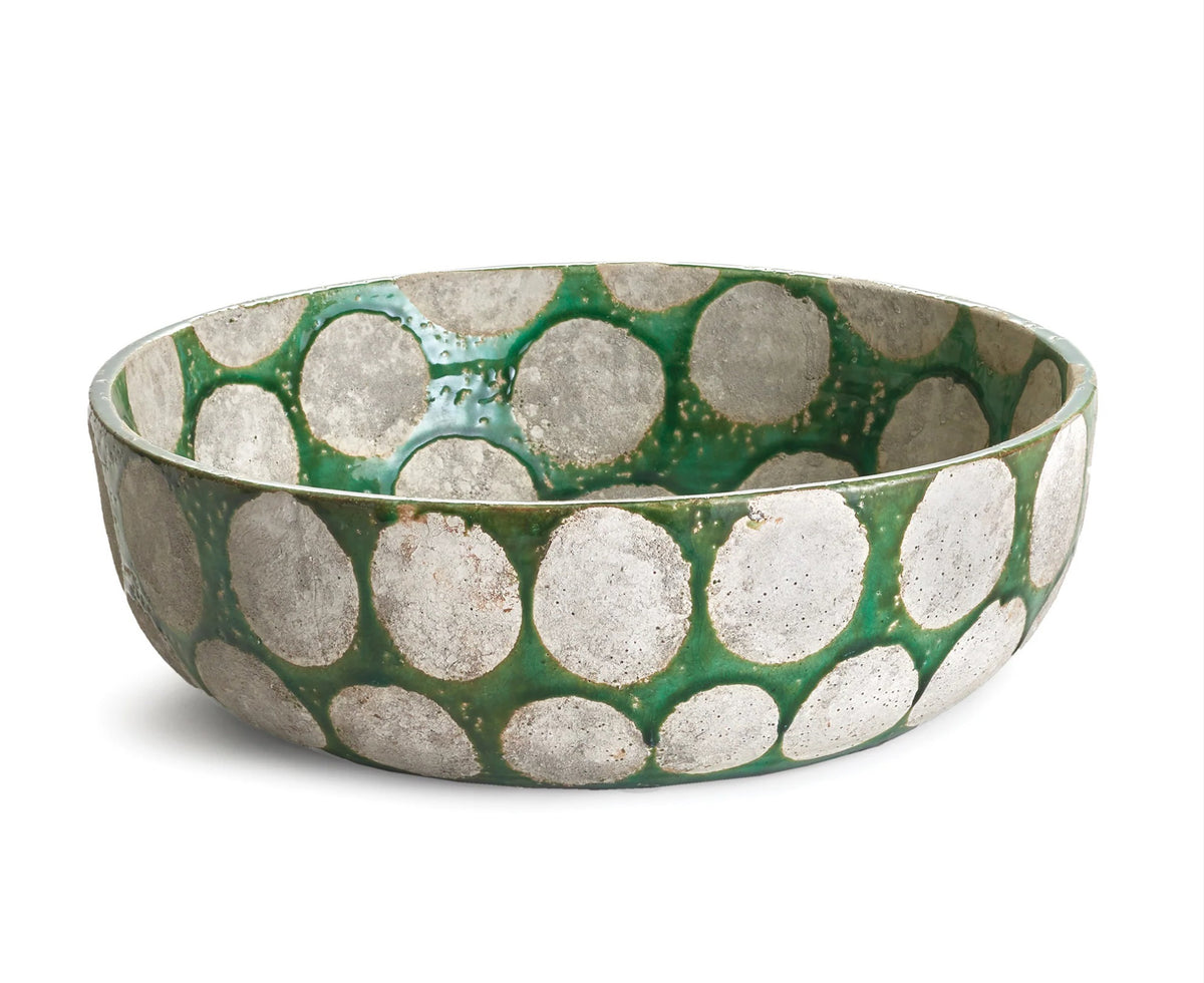 The NAPA HOME AND GARDEN KILEY BOWL IN GREEN is a round ceramic bowl with a glossy green base and bold silver circles on its surfaces, reflecting mid-century style. Shown here on a white background, it's perfect as a decorative fruit bowl.