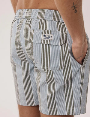 HARTFORD Seersucker Swim Trunks in green and blue stripes for men feature an elastic waistband, white drawstring, and olive accents. These mid-length swim shorts offer a classic look in textured seersucker fabric, shown on a light background.