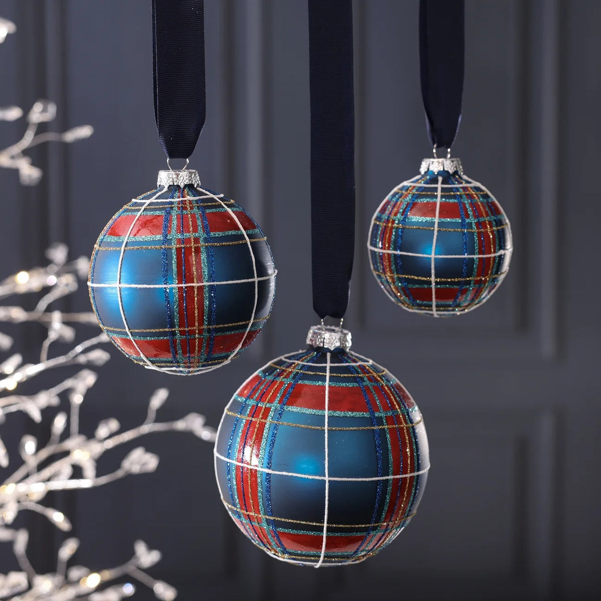 ZODAX GLASS PLAID ORNAMENT BALL, a round 4.75-inch glass Christmas ornament with a red and blue plaid pattern accented by glittery stripes.