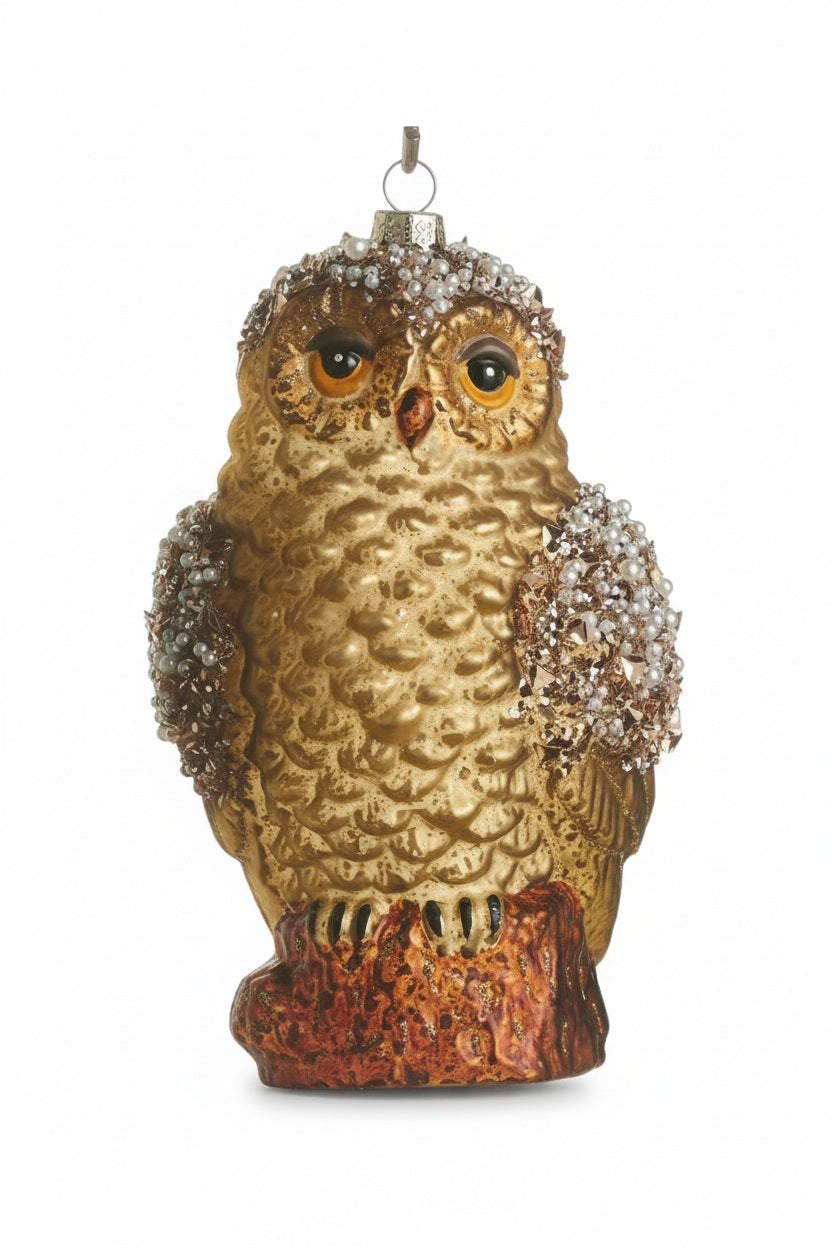 JEWELED OWL ORNAMENT perched on a decorative glass container, featuring beaded accents on its head and wings.