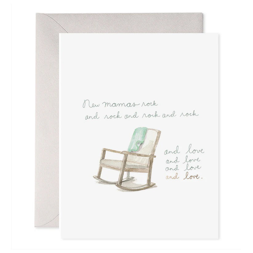 The E. FRANCES PAPER - NEW MAMAS ROCK GREETING CARD features a handcrafted watercolor of a rocking chair with a light green cushion, alongside the words "New mamas rock and rock and rock and love and love and love." An envelope is slightly visible behind the card.