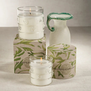 The ZODAX GRAND CASABLANCA CANDLE - WILD TUBEROSE, 12 OZ fills the room with a warm glow and wild tuberose scent in a clear, textured glass holder—perfect for a cozy ambiance or pairing with a botanical gift box.