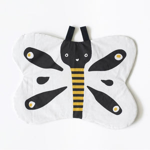 The WEE GALLERY - BUTTERFLY ORGANIC CRINKLE is a children's soft fabric toy, crafted from organic cotton. It features a butterfly shape with a smiling face in the center and a striped yellow and black body. The white wings are adorned with black patterns and yellow accents, providing visual stimulation. Additionally, it includes a small loop at the top for hanging.