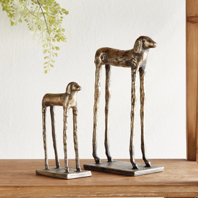 The NAPA HOME AND GARDEN - HOUND DOG SCULPTURES feature two metallic, abstract hounds with elongated legs on rectangular bases (one taller). Modern desk decor or a gold bookshelf accent by NAPA HOME AND GARDEN.