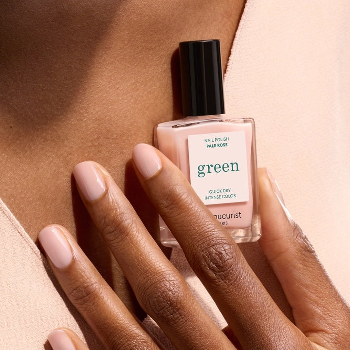 Five glossy-finished, non-toxic MANUCURIST nail polish swatches—including the GREEN™ NAIL POLISH IN PALE ROSE—labeled Milky White, Milky Pink, Hortencia, Pale Rose, and Beige, display a gradient of shades ranging from white through pale pink to nude tones.