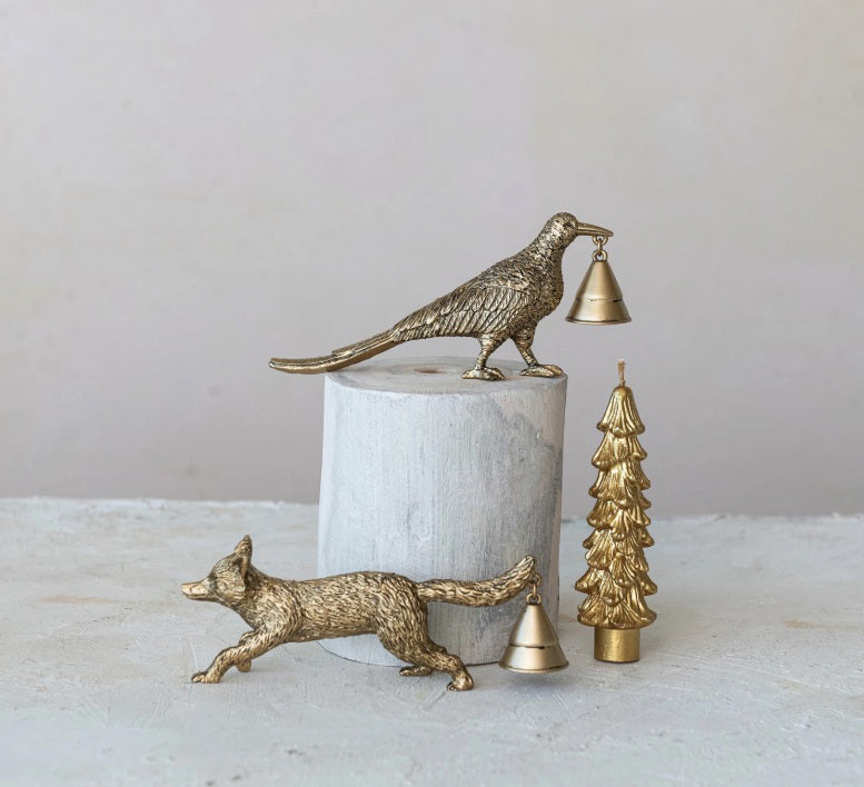 Three zinc alloy CREATIVE COOP ANIMAL CANDLE SNUFFERS—fox, bird with bell on white cylinder, and Christmas tree with bell—are displayed on a light surface against a plain gray background.