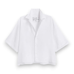 The FRANK & EILEEN Rosie Short Sleeve Button Up Shirt in white linen features a wide collar, loose fit, and "Frank & Eileen" label inside the collar. This women's shirt is shown on a white background.