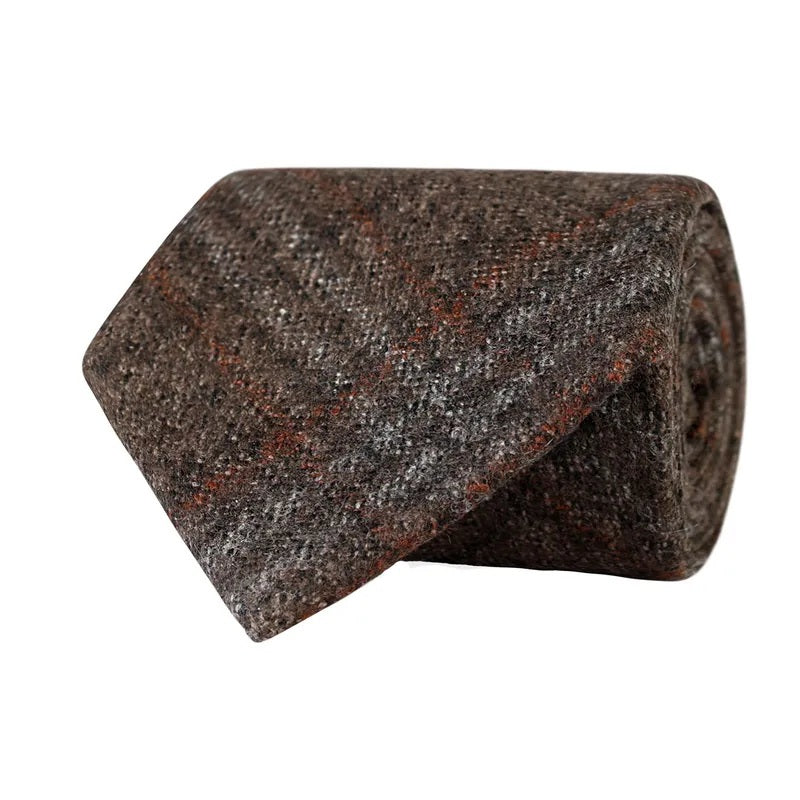 A rolled-up AMANDA CHRISTENSEN Checked Wool Tie in brown, crafted from fine Italian wool with a subtle plaid pattern in shades of gray and rust, displayed on a white background.