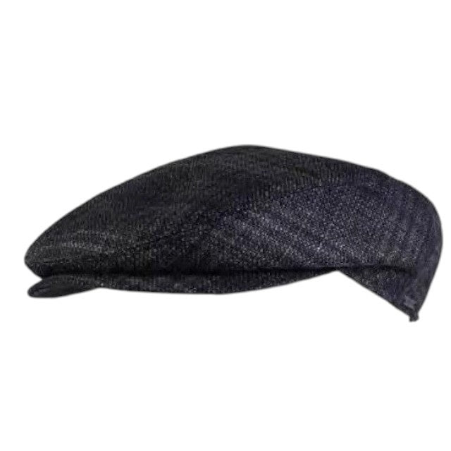 Close-up of the WIGENS - IVY SLIM ITALIAN SOFT CHECK CAP IN GREY by WIGENS, featuring dark gray woven fabric with a subtle check pattern created by intersecting lighter threads. The tightly woven texture has a slightly rough feel, making it an excellent choice for this classic Italian-inspired wool flat cap.