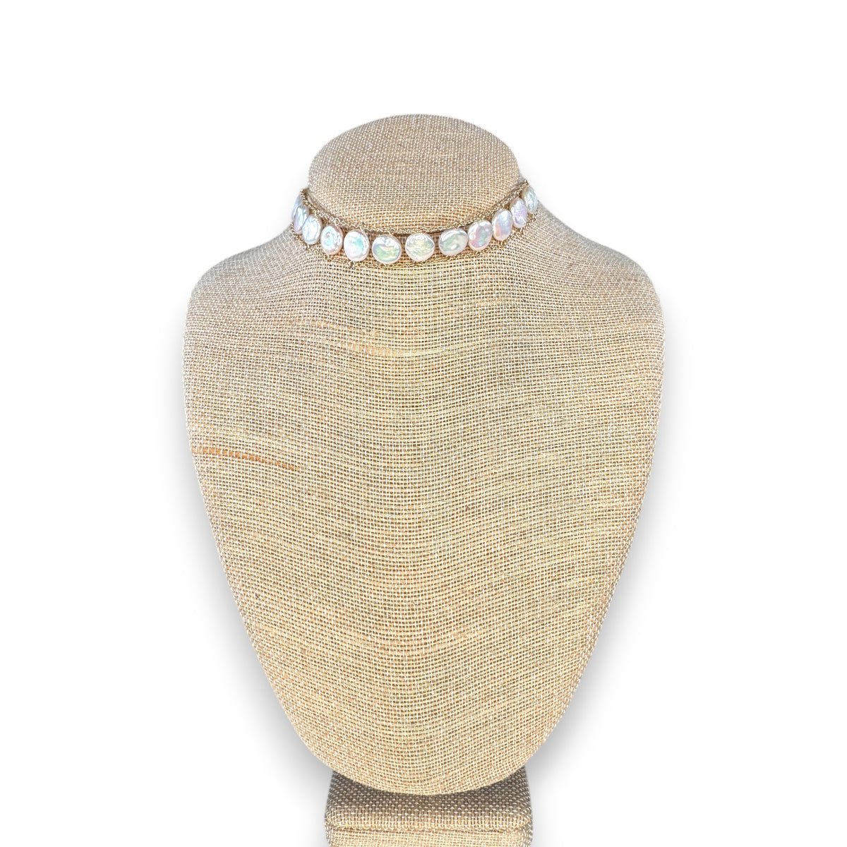 A woman wears the GOLDISH - LADDERS TO BLISS WHITE PEARL CHOKER by GOLDISH, a double-layered lightweight necklace with round white pearls on a gold linked chain, shown against a neutral background.