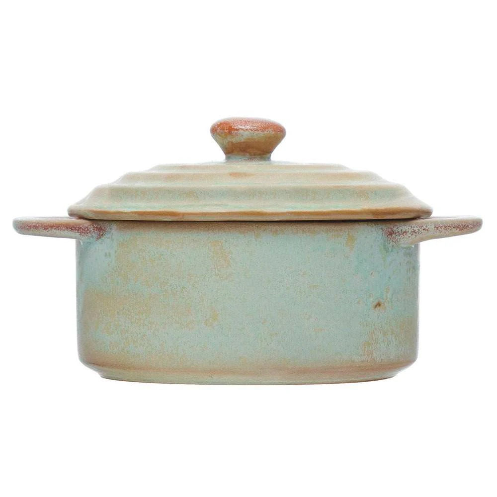 Introducing the MINI STONEWARE BAKER WITH LID by CREATIVE COOP—a rustic, round ceramic pot with side handles and a matching lid. Crafted in striking blue-green and brown hues, this mini baker features a reactive crackle glaze for distinctive texture. The lid is topped with an easy-to-grip knob handle, making it ideal for serving individual casseroles in style.