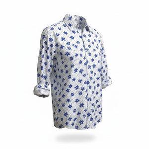 A man with short gray hair and a beard wears the FRANK & EILEEN Finbar Men's Button Up Shirt in Blue and White Small Flowers Big Flowers. He pairs it with dark jeans, standing against a plain white background for an everyday look.