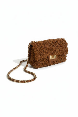 The VICARIO CINQUE Brescia Bag in brown by VICARIO CINQUE showcases a soft, curly bouclé texture with a modern rectangular gold clasp on the front, embodying Italian-inspired chic style and contemporary elegance.