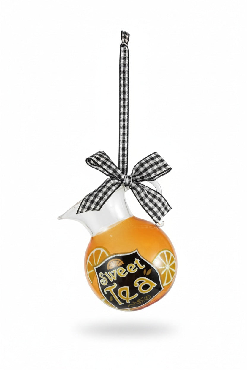 A SWEET TEA PITCHER ORNAMENT WITH LEMONS shaped like a pitcher filled with amber liquid, decorated with lemon slices and a “Sweet Tea” label, finished with a black and white gingham ribbon bow.