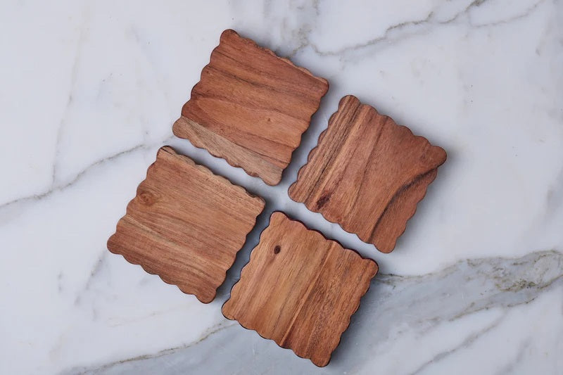 The ETUHOME Scalloped Wood Coasters, Set of 4, features square coasters with wavy scalloped edges, neatly stacked atop each other against a white background.