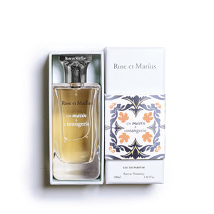 A rectangular glass bottle of ROSE ET MARIUS - A MORNING AT THE ORANGERY EAU DE PARFUM 30ML stands with a geometric cap; a round "Unisexe" label highlights its fresh citrus and orange blossom notes.