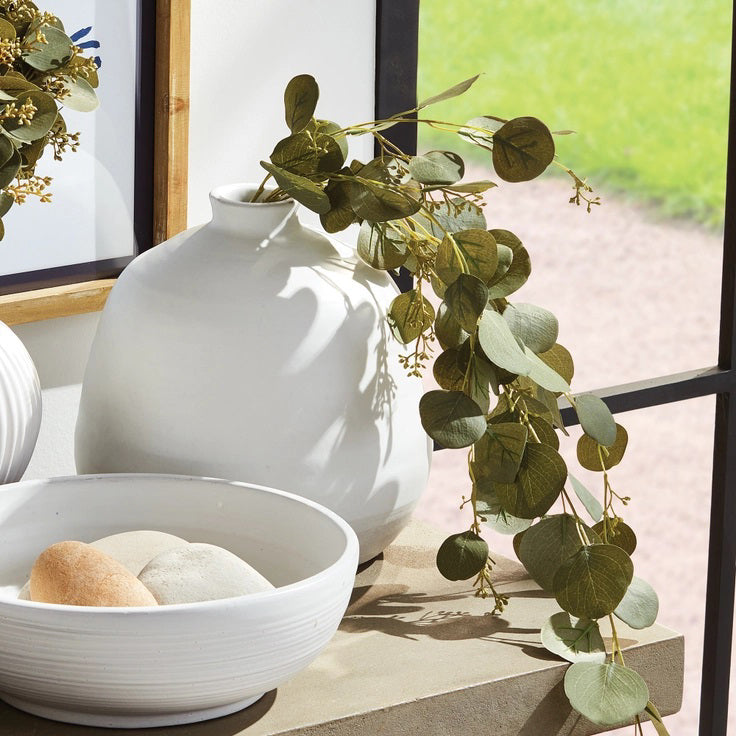 The NAPA HOME AND GARDEN - SILVER DOLLAR EUCALYPTUS SPILLER features cascading green leaves and small white flowers on slender stems, ideal for crafting a stunning greenery garland or centerpiece.