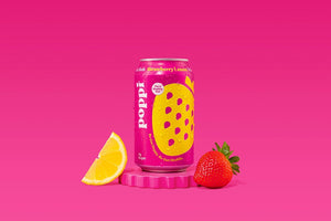 A pink POPPI - STRAWBERRY LEMON can features a large yellow strawberry graphic, white and yellow text, and "For a Healthy Gut" on top. It highlights 4g sugar and prebiotics for gut health. Brand: POPPI.