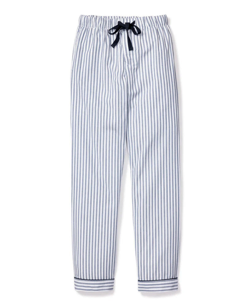 The FEARRINGTON LIFESTYLE COLLECTION - MEN&#39;S TWILL PAJAMA PANT IN NAVY FRENCH TICKING by PETITE PLUME is a pair of pajama pants adorned with white and blue vertical stripes. Made from the finest quality cotton, these luxurious pants feature a black drawstring waist and black trim at the cuffs. Laid flat on a white background, they proudly display their elegant French ticking design.