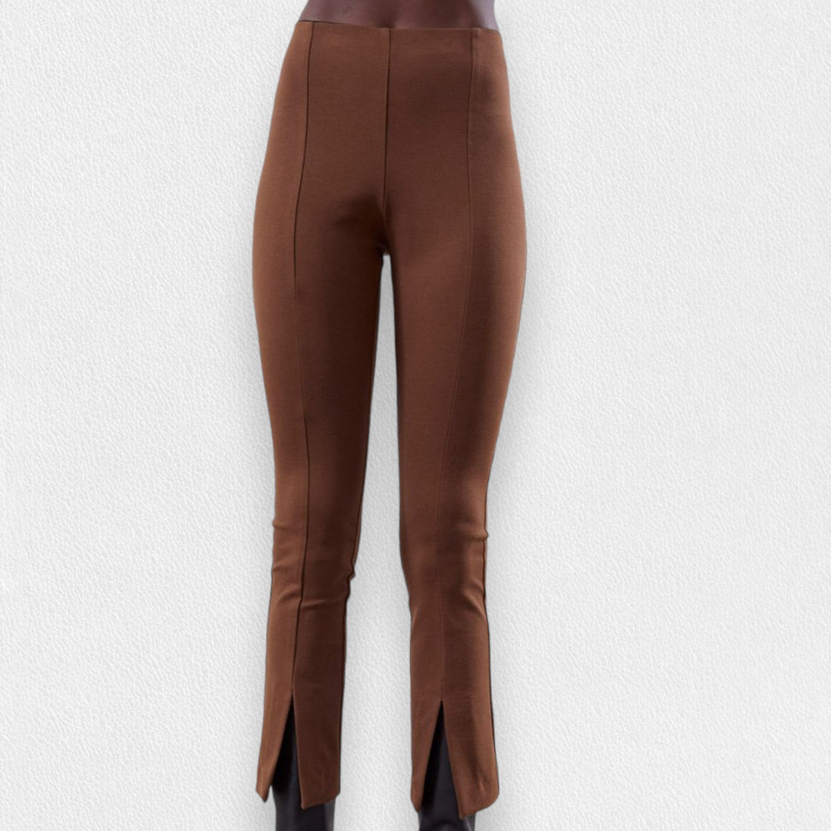 The MEIMEIJ - CROPPED STRETCH FRONT SLIT PANT is a pair of dark navy blue, high-waisted, straight-leg pull-on pants with a tailored fit and smooth finish, featuring front slit hems. Displayed against a light grey textured background, these MADE IN ITALY pants exude elegance and style.