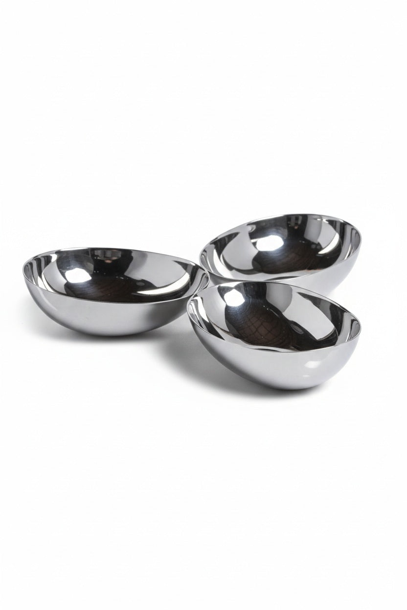 Three connected, polished nickel TRIPLE NUT BOWL alloy bowls arranged in a cluster on a square plate.