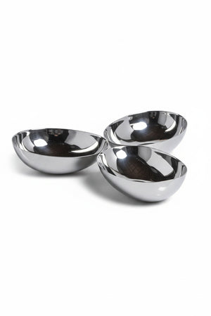 Three connected, polished nickel TRIPLE NUT BOWL alloy bowls arranged in a cluster on a square plate.