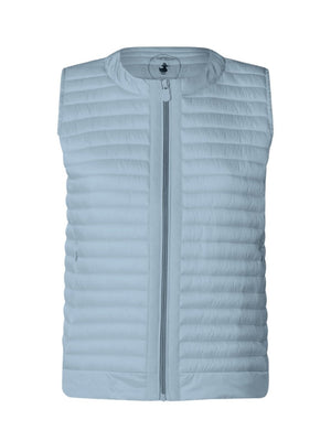 An older woman with short gray hair wears the SAVE THE DUCK - MARA PUFFER VEST over a white t-shirt and beige pants, standing against a light background—perfect for spring–summer layering from SAVE THE DUCK.