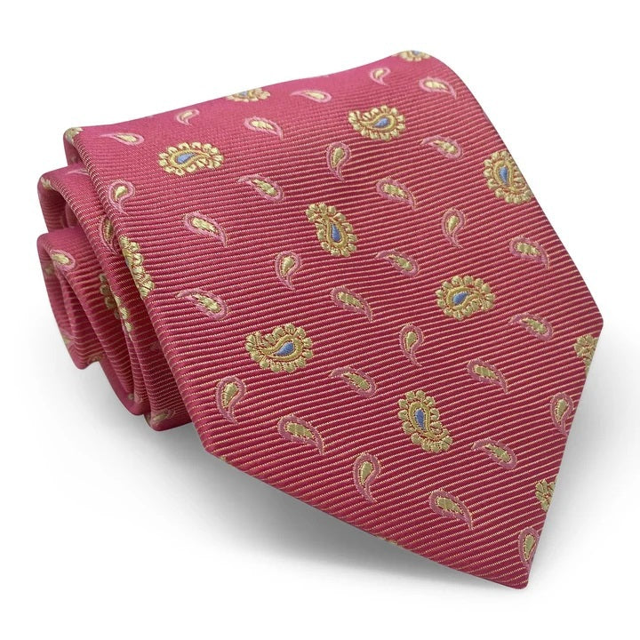 A handmade 100% silk necktie by BIRD DOG BAY, the PETER-BLAIR - BESPOKE HERO PAISLEY SILK TIE features a paisley pattern in red, pink, and yellow, and is displayed rolled on a white background.