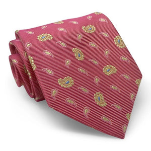 A handmade 100% silk necktie by BIRD DOG BAY, the PETER-BLAIR - BESPOKE HERO PAISLEY SILK TIE features a paisley pattern in red, pink, and yellow, and is displayed rolled on a white background.