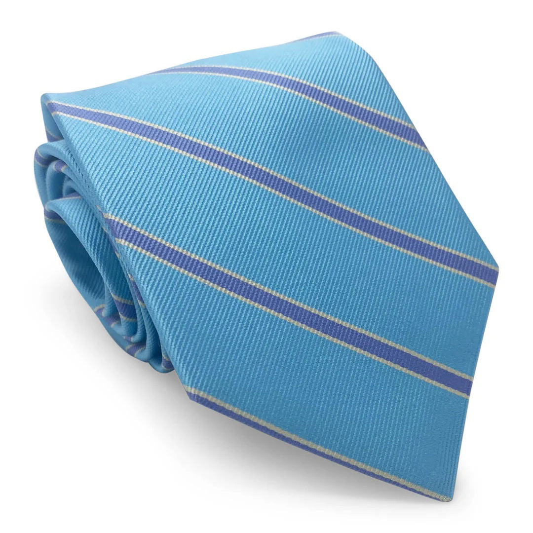 The BIRD DOG BAY PETER BLAIR - WHISTLER TIE IN AQUA is a handmade light blue silk tie with thin purple and white diagonal stripes, made in New York and displayed on a white background.
