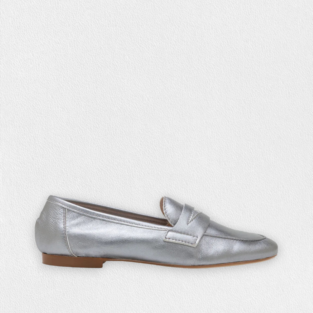 A single MICHELE LOPRIORE - PAOLA LOAFER in black is displayed against a plain white background. The shoe features a sleek and minimal design with genuine leather, a low heel, and a classic penny strap across the top, exuding an understated moccasin style by MICHELE LOPRIORE.