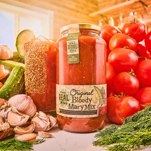 A 32oz jar of THE REAL DILL - ORIGINAL BLOODY MARY MIX features a beige label and a lid tag, filled with thick, reddish pickle Bloody Mary mix perfect for crafting premium cocktails. This fresh-pressed cucumber mixer by THE REAL DILL delivers bold, garden-fresh flavor to enhance your favorite Bloody Mary recipes.