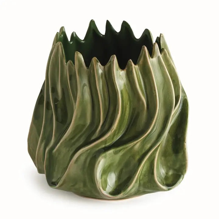 The NAPA HOME AND GARDEN - GREEN CALLISTA VASE, MEDIUM features a sculptural design with glossy green handcrafted ceramic, showcasing wavy, flame-like edges and ridges that evoke the look of abstract leaves or flames. A high-gloss reactive glaze accentuates its flowing, organic exterior shapes, while the interior is finished in a rich dark green.
